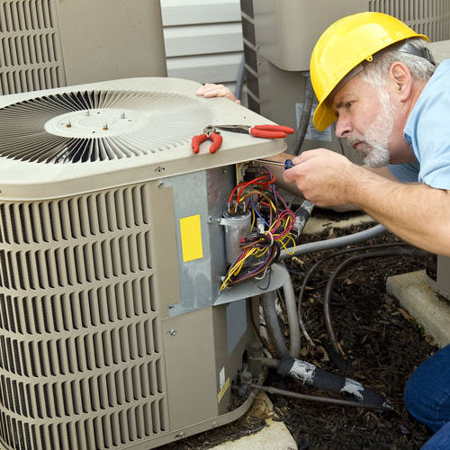 HVAC Technician Repairs an Air Conditioner.